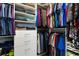 A closet featuring built in shelving, drawers, shoe storage and many hanging garments at 3602 Quiet Dr, Sarasota, FL 34240