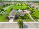 Aerial view of a clubhouse with playground, surrounded by manicured landscaping and green spaces in a residential community at 3602 Quiet Dr, Sarasota, FL 34240