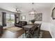 Elegant dining room with stylish furnishings, a modern chandelier, and natural light from the window at 3602 Quiet Dr, Sarasota, FL 34240