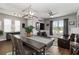 Elegant dining room with stylish furnishings, a modern chandelier, and natural light from the windows at 3602 Quiet Dr, Sarasota, FL 34240