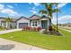 Inviting single-story home with a well-manicured lawn and a striking turquoise-colored front door at 3602 Quiet Dr, Sarasota, FL 34240