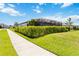 View of the manicured lawn and lush shrubbery lining the walkway to this lovely home at 3602 Quiet Dr, Sarasota, FL 34240