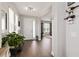 Bright foyer with hardwood floors, a white door, and a glimpse into the living room at 3602 Quiet Dr, Sarasota, FL 34240