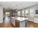 Modern open kitchen with large island, stainless steel appliances, and a view to the living room at 3602 Quiet Dr, Sarasota, FL 34240