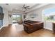 Cozy living room with leather sofa, ceiling fan, and sliding glass doors to the patio at 3602 Quiet Dr, Sarasota, FL 34240