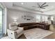 Inviting living room features a leather sofa, ceiling fan, and ample natural light at 3602 Quiet Dr, Sarasota, FL 34240