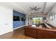 Stylish living room with custom blue accent wall, ceiling fan, and a leather sofa at 3602 Quiet Dr, Sarasota, FL 34240