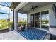 Enjoy the outdoors on this covered patio with cozy seating, a ceiling fan, and scenic views at 3602 Quiet Dr, Sarasota, FL 34240