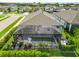 Aerial view of the caged pool with patio furniture surrounded by lush landscaping and a well-manicured lawn at 3602 Quiet Dr, Sarasota, FL 34240
