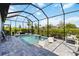 Relaxing screened pool area with a water feature, comfortable seating, and well-maintained landscaping at 3602 Quiet Dr, Sarasota, FL 34240