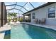 Captivating screened-in pool area with stylish seating, a tranquil water feature, and lush surroundings at 3602 Quiet Dr, Sarasota, FL 34240