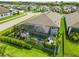 Aerial view of the screened-in pool with seating and an outdoor patio, complemented by landscaping and green grass at 3602 Quiet Dr, Sarasota, FL 34240