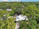 An aerial view of a charming home featuring a new metal roof surrounded by lush greenery at 4023 Hina Dr, Sarasota, FL 34241