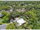 Aerial view showcasing the home nestled among mature trees in a tranquil neighborhood at 4023 Hina Dr, Sarasota, FL 34241