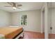Bright bedroom featuring a ceiling fan, large window, and minimalist decor at 4023 Hina Dr, Sarasota, FL 34241