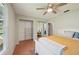 Bright bedroom featuring wood floors, a ceiling fan, and a closet with built-in storage at 4023 Hina Dr, Sarasota, FL 34241