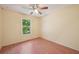 Bright bedroom featuring wood floors, a window with green views and a ceiling fan at 4023 Hina Dr, Sarasota, FL 34241