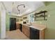 Functional kitchen featuring wood cabinets, open shelving, and essential appliances with ample counterspace at 4023 Hina Dr, Sarasota, FL 34241
