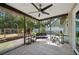 Covered, screened porch with a tile floor and views of the backyard and garden at 4023 Hina Dr, Sarasota, FL 34241