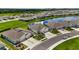 Aerial view of home with pond, manicured lawns, and community at 407 157Th E Ct, Bradenton, FL 34212