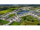 Scenic aerial view of a community with lush green landscaping, a lake, and beautiful homes at 407 157Th E Ct, Bradenton, FL 34212
