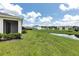 Expansive backyard with lush lawn and serene pond views creating a tranquil outdoor space at 407 157Th E Ct, Bradenton, FL 34212