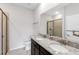 Bathroom with double vanity, granite countertops, and a glass-enclosed shower at 407 157Th E Ct, Bradenton, FL 34212