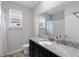 Bathroom with a granite countertop vanity and shower behind a curtain at 407 157Th E Ct, Bradenton, FL 34212