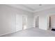 A bedroom with multiple doors and a view to the ensuite bathroom and walk-in closet at 407 157Th E Ct, Bradenton, FL 34212