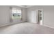 Bedroom with a large window showing the backyard and a view to the outside patio at 407 157Th E Ct, Bradenton, FL 34212