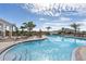 Beautiful community pool with lounge chairs, palm trees, and a relaxing resort-style atmosphere at 407 157Th E Ct, Bradenton, FL 34212