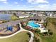 Aerial view of a community pool, playground, and recreation area nestled among beautiful homes at 407 157Th E Ct, Bradenton, FL 34212