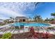 Gorgeous community pool with inviting lounge areas, lush landscaping, and a clubhouse at 407 157Th E Ct, Bradenton, FL 34212