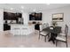 Modern kitchen with dark cabinets, stainless steel appliances, and dining area at 407 157Th E Ct, Bradenton, FL 34212