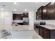 Kitchen featuring dark cabinets, granite countertops, stainless steel appliances and breakfast bar at 407 157Th E Ct, Bradenton, FL 34212
