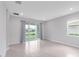 Open space featuring tile floors, large windows, and sliding glass door at 407 157Th E Ct, Bradenton, FL 34212