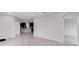 Open-concept living area with tile flooring and access to kitchen and bedroom at 407 157Th E Ct, Bradenton, FL 34212