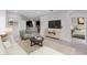 Comfortable living room with neutral decor and open flow to the kitchen at 407 157Th E Ct, Bradenton, FL 34212