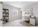 A home office with a desk, bookshelves, and natural light at 407 157Th E Ct, Bradenton, FL 34212