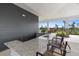 Stylish outdoor kitchen featuring a granite countertop bar with seating and picturesque views at 407 157Th E Ct, Bradenton, FL 34212