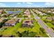 Extensive aerial view of a well-maintained neighborhood featuring a tranquil pond and tree-lined streets at 408 166Th E St, Bradenton, FL 34212