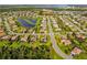 Expansive aerial view of a residential neighborhood featuring lush landscaping, ponds, and well-maintained streets at 408 166Th E St, Bradenton, FL 34212