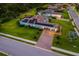 Aerial view of a home with solar panels, a three-car garage, and manicured lawns at 408 166Th E St, Bradenton, FL 34212