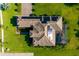 Overhead view of beautiful tiled roof, green backyard and solar panels at 408 166Th E St, Bradenton, FL 34212