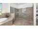 Bright bathroom featuring a glass shower and soaking tub at 408 166Th E St, Bradenton, FL 34212