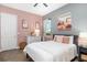 Charming bedroom with pink and grey color scheme and stylish decor at 408 166Th E St, Bradenton, FL 34212