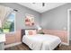 Cozy bedroom with decorative wall tapestry, paneled walls, and a large window at 408 166Th E St, Bradenton, FL 34212
