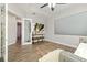 Bonus room featuring a large projection screen, wood floors, and comfortable seating at 408 166Th E St, Bradenton, FL 34212