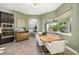 Cozy dining area with a view of the lanai and a modern light fixture at 408 166Th E St, Bradenton, FL 34212