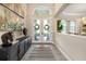 Welcoming foyer with double front doors, decorative wreaths, and tile flooring at 408 166Th E St, Bradenton, FL 34212